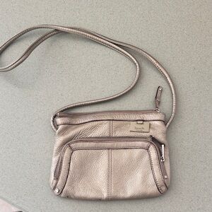 Silver Metallic Leather Crossbody Bag by Tiganello.